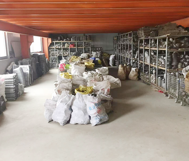 Catalytic converters and exhaust components neatly arranged in a warehouse, showcasing a variety of car exhaust systems and pipes for efficient storage and selection.